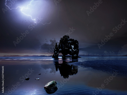 Hvitserkur 15 m height. Is a spectacular rock in the sea on the Northern coast of Iceland. On this photo Hvitserkur reflects in the sea water after the midnight thunderstorm photo