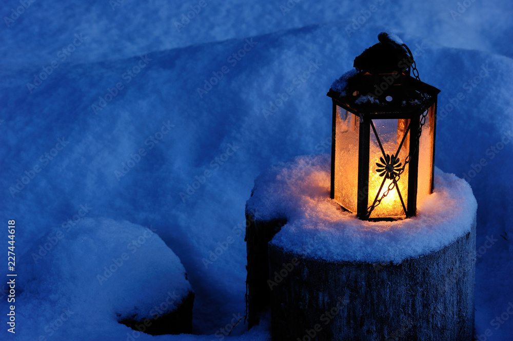 Christmas candle lantern in the snow