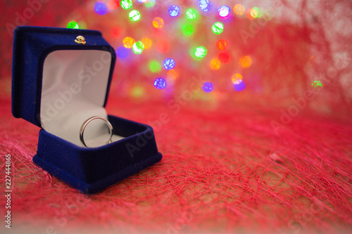 Engagement ring on colorful red background. © layue