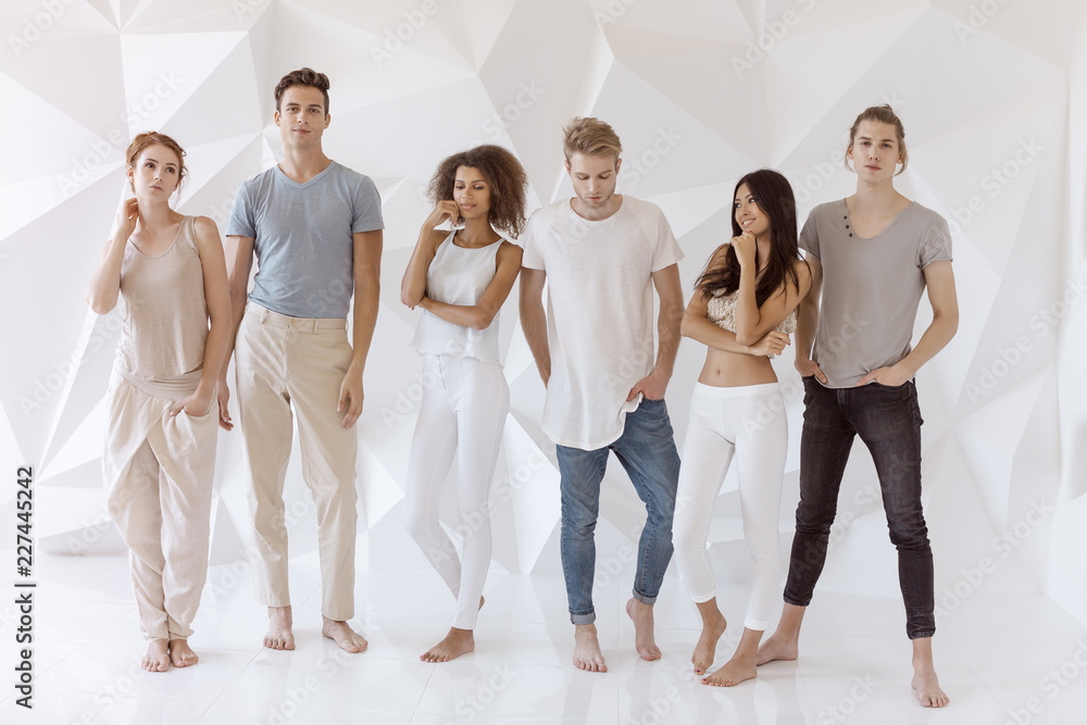 Group of young multi-ethnic beautiful people wearing casual clothes smiling  and having fun together against white abstract polygonal background. Asian  Caucasian Afro-American attractive stylish men Stock Photo | Adobe Stock