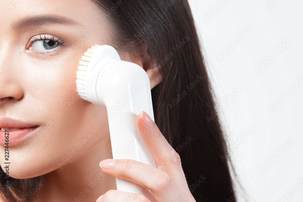 Young beautiful woman uses the apparatus for peeling Young beautiful woman uses the apparatus for peeling