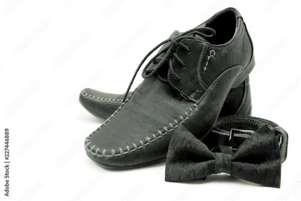 Black shoes, belt and bow tie isolated on white background Black shoes, belt and bow tie isolated on white background