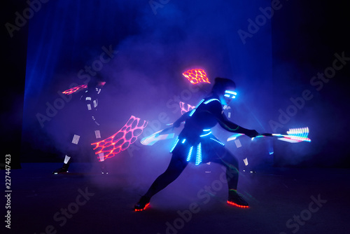 Laser show performance  dancers in led suits with LED lamp  very beautiful night club performance  party