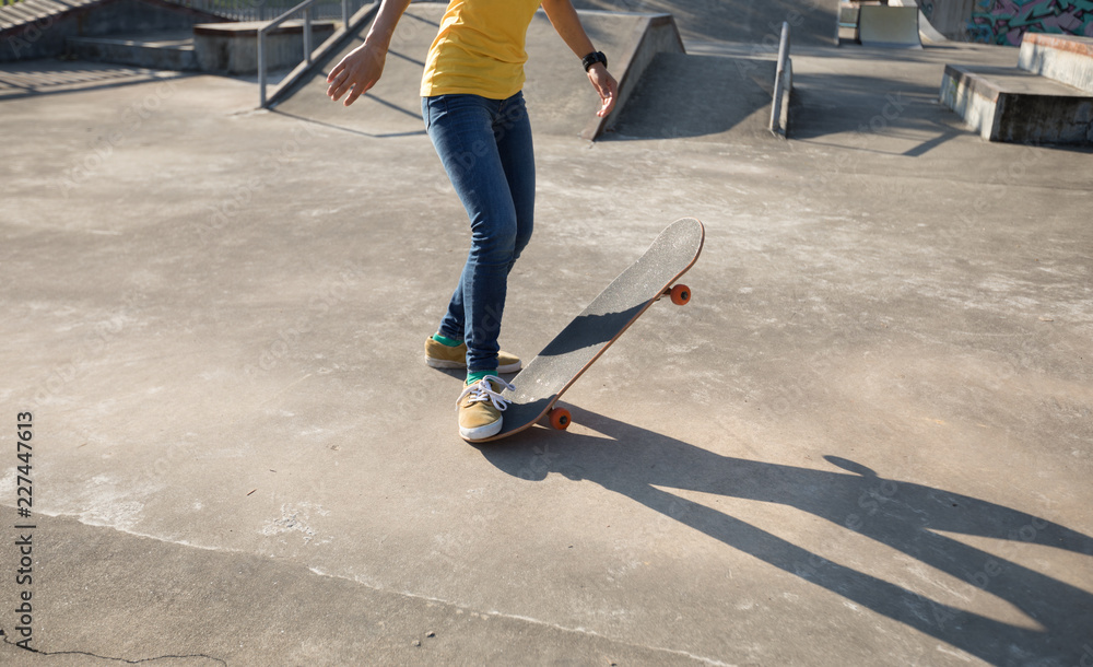Skateboarder skateboarding at skatepark Skateboarder skateboarding at skatepark