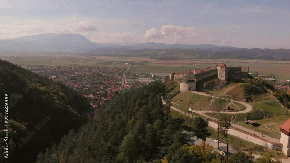 Aerial view of Rasnov town and Fortress with beautiful nature. Brasov, Transylvania, Romania. Autumn, sunny day . Aerial view of Rasnov town and Fortress with beautiful nature. Brasov, Transylvania, Romania. Autumn, sunny day .