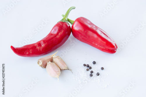 Hot pepper with garlic, pepper and salt on a white background