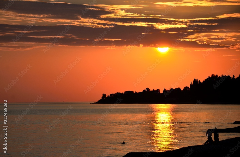 View of the Black sea at sunset, with people resting.