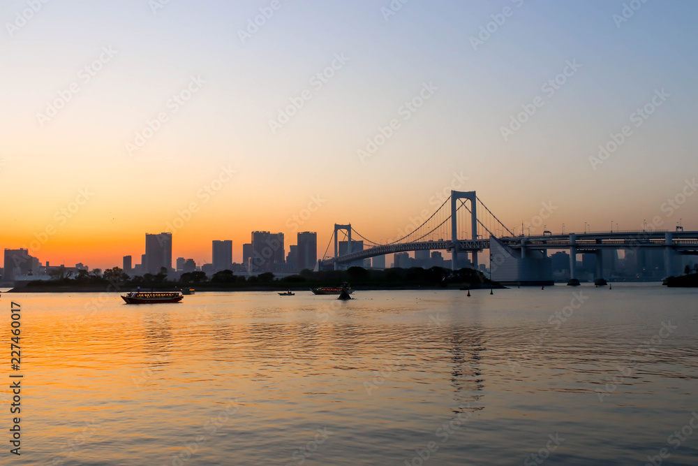 View of sunset and boats and rainbow bridge at sumida river sunset viewpoint ,tokyo