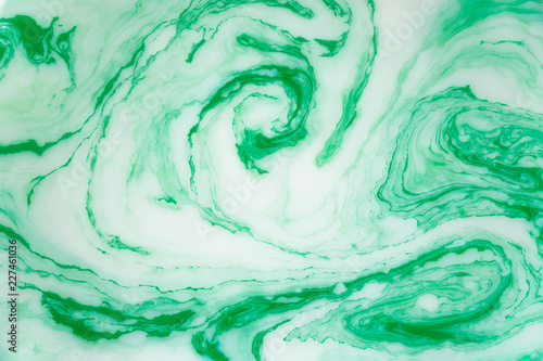 Abstract green marble background. Stains of paint on the water.