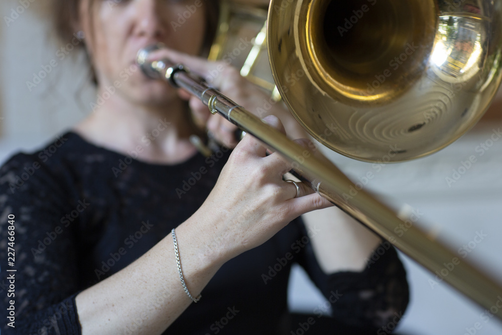 Obraz premium Hands of a girl playing the trombone