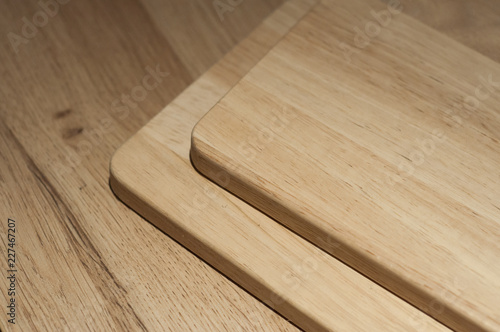 closeup of wooden cutting board on wooden table background