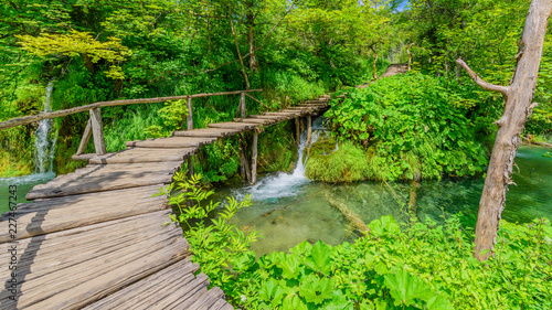 PLITVICE NATIONAL PARK, CROATIA - JUNE 8, 2018: Tourist group by the lake in the Plitvice Lakes National Park.