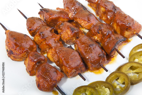 close-up view on a dish of Shish Taouk with a side of pickled Jalapeno 