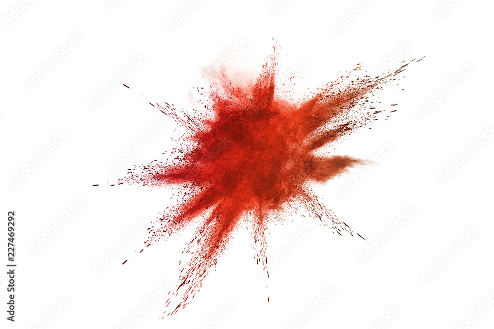 Abstract red powder explosion. Closeup of red dust particle splash isolated on white background