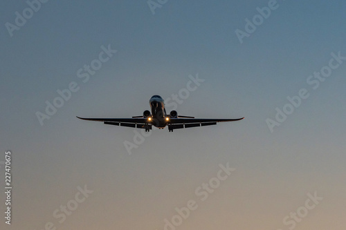 The airliner approaches the evening. photo