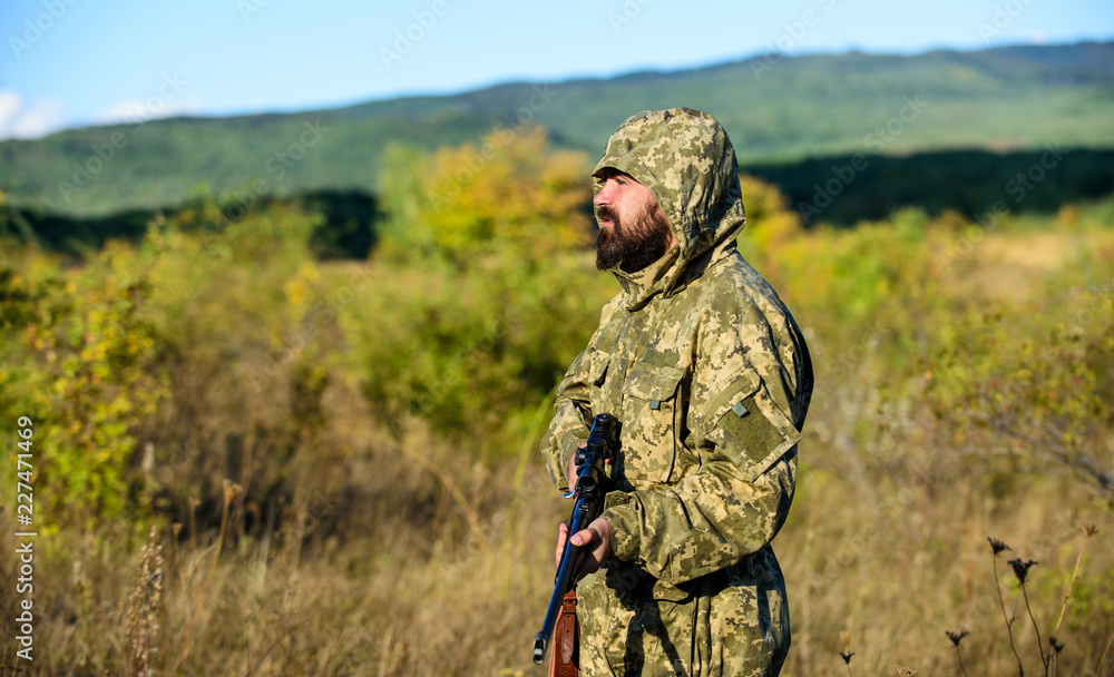 Hunting season. Man bearded hunter with rifle nature background. Experience and practice lends success hunting. How turn hunting into hobby. Guy hunting nature environment. Masculine hobby activity