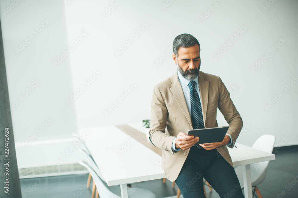 Handsome mature businessman with digital tablet Handsome mature businessman with digital tablet