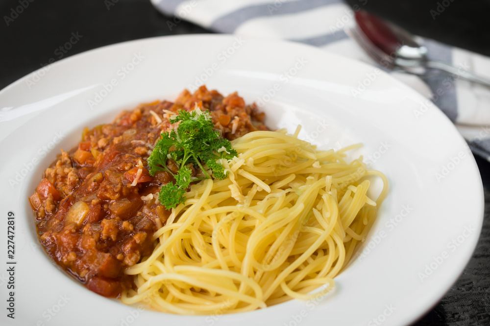 Spaghetti with tomato sauce in plate.