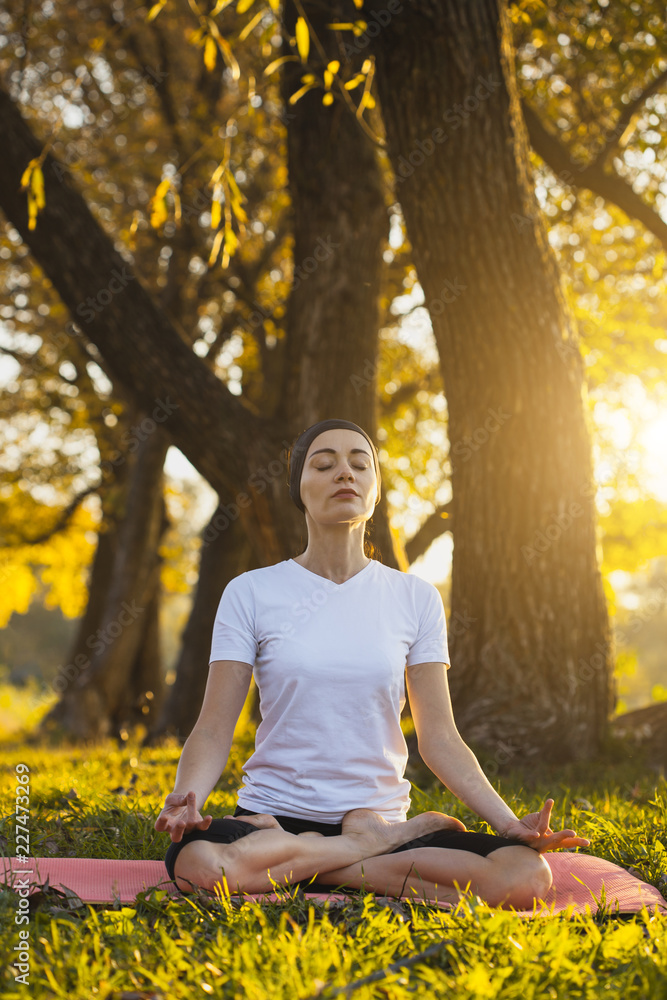 Beautiful young girl meditating in autumn park Beautiful young girl meditating in autumn park