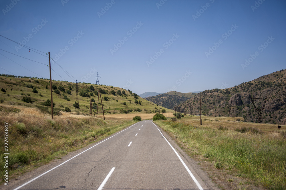 Asphalt road running through a beautiful mountain landscape