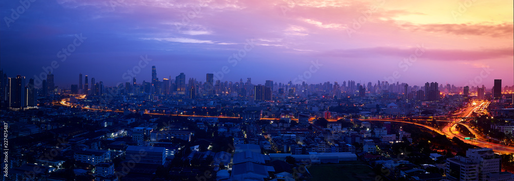 Naklejka premium panorama miasta z wschód słońca i światła drogi ekspresowej
