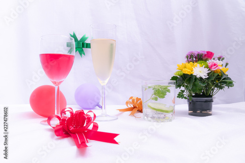 Set of drinks with beautification on table covered by white cloth.