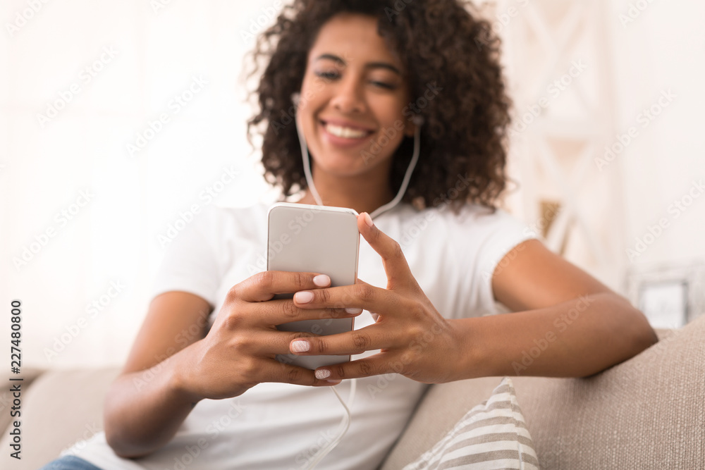 African-american woman looking at mobile phone display African-american woman looking at mobile phone display
