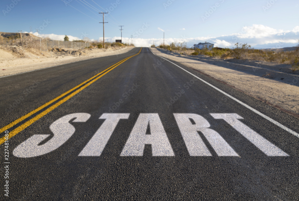 new beginnings, travel and adventure concept - close up of word start on suburban asphalt road