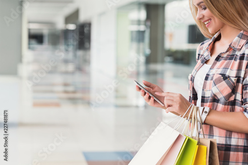 Happy woman doing online shopping on mobile phone