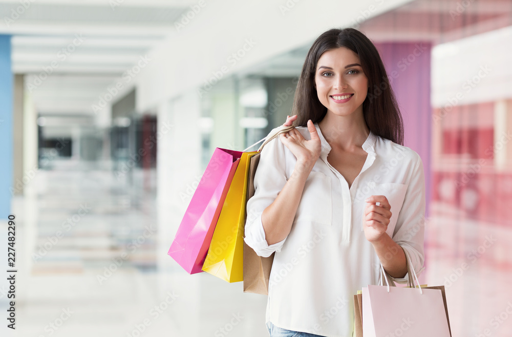 Portrait of happy young woman with shopping bags Portrait of happy young woman with shopping bags