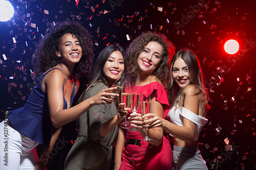 Happy women celebrating New Year at nightclub