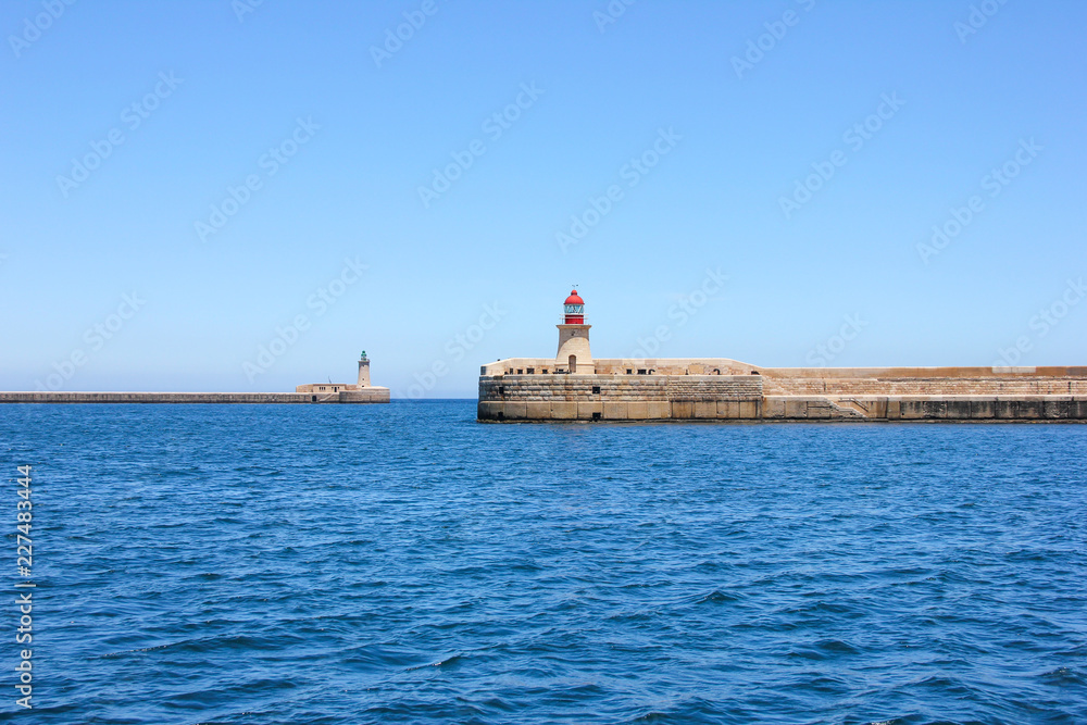 Two lighthouses on calm sea in Grand Harbor in Valletta, Malta