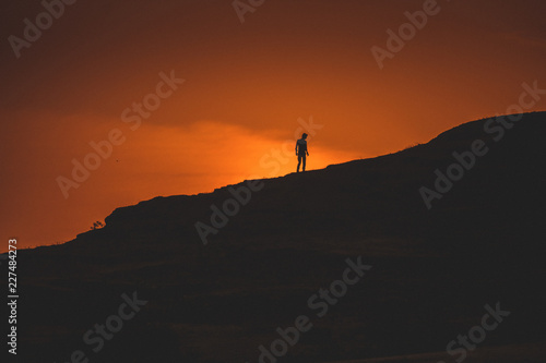 silhouette of man on top of mountain at sunset © Shiv Mer