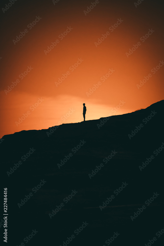 Silhouette of man on top of mountain