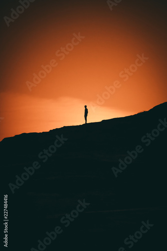 Silhouette of man on top of mountain