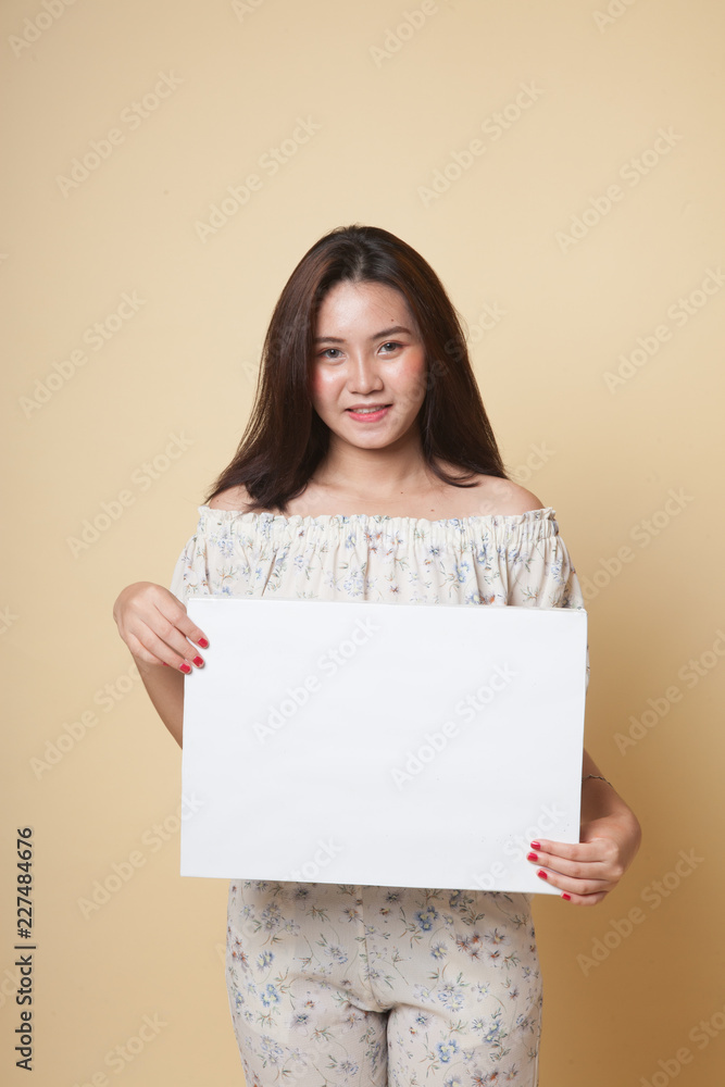 Young Asian woman with white blank sign. Young Asian woman with white blank sign.