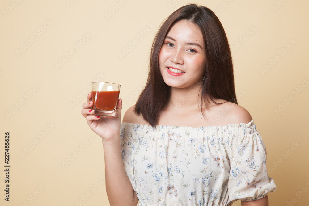 Young Asian woman drink tomato juice. Young Asian woman drink tomato juice.