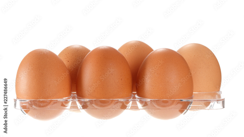 Eggs in transparent container from refrigerator isolated on white background Eggs in transparent container from refrigerator isolated on white background
