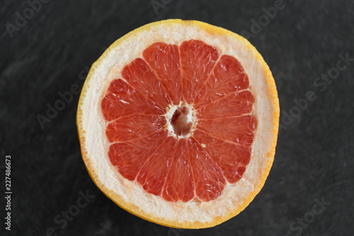 food, fruits and healthy eating concept - close up of fresh juicy grapefruit