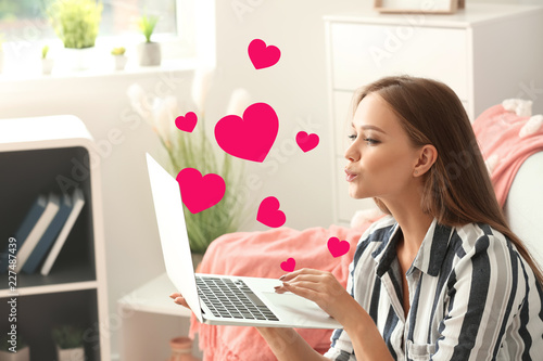Young woman using laptop fo...