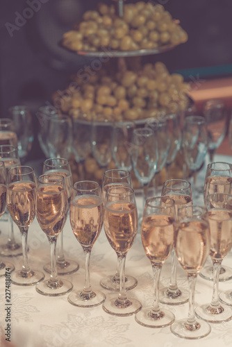 Glasses of champagne waiting for guests, retro toned