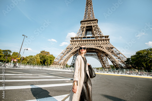 Canvas Print Lifestyle portrait of a young stylish woman crossing the street in front of the