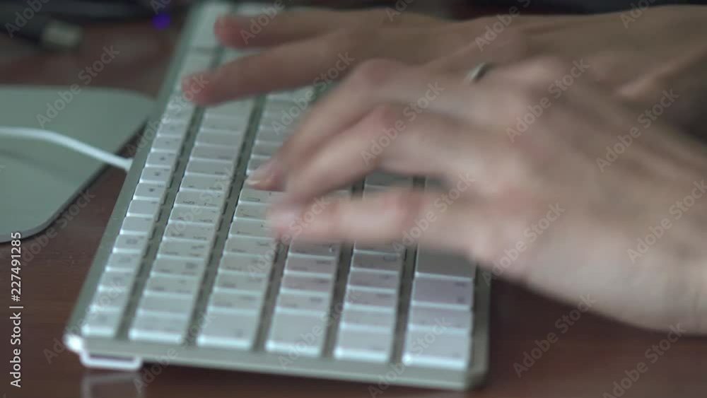 Woman's hands typing on computer keyboard close up Woman's hands typing on computer keyboard close up