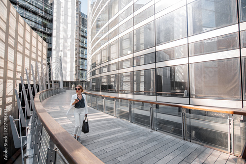 Photography Business woman walking outdoors at the financial district with modern buildings