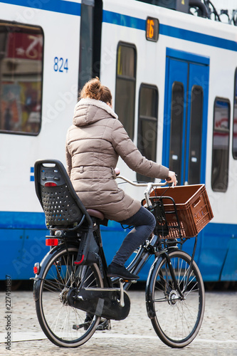 Cyclist in a cold early spring day at the Old Central district of Amsterdam