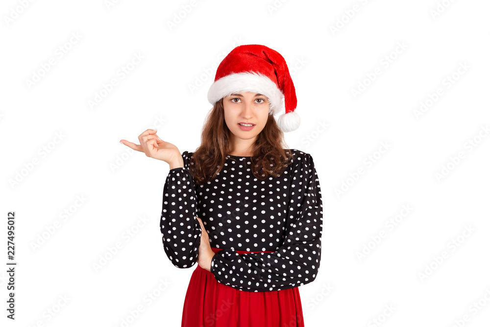 Portrait of feminine displeased gesturing with finger in no or refusal gesture. emotional girl in santa claus christmas hat isolated on white background. holiday concept Portrait of feminine displeased gesturing with finger in no or refusal gesture. emotional girl in santa claus christmas hat isolated on white background. holiday concept