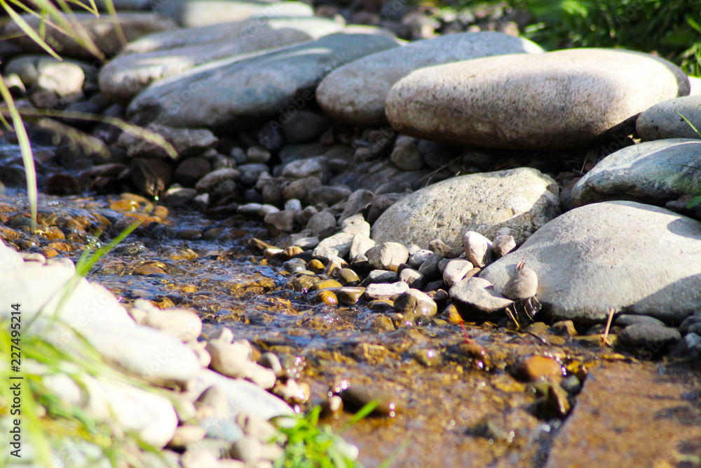 Rocks in stream with smooth flowing water Rocks in stream with smooth flowing water