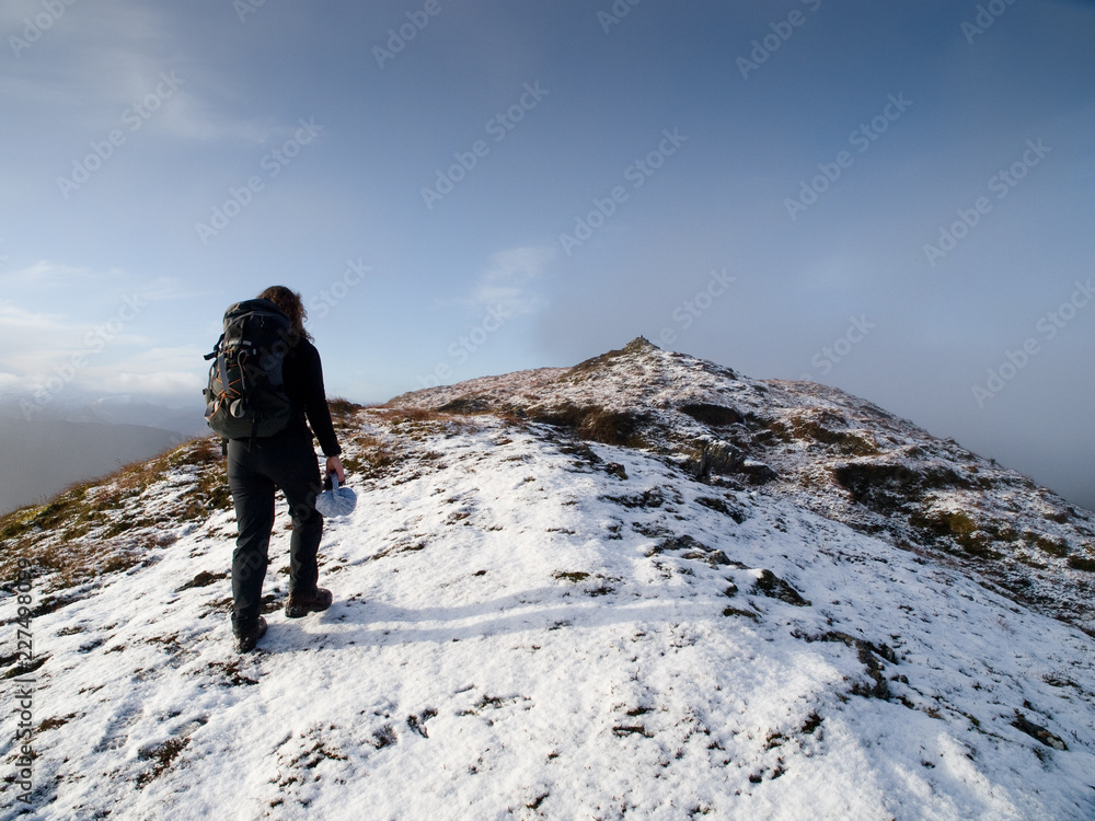 A climber reaching the hill top