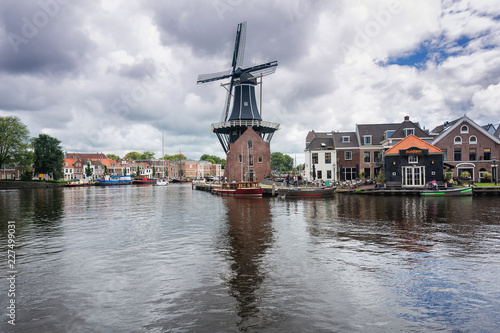 The eight-sided smock mill De Adriaan on the river De Spaarne in Haarlem