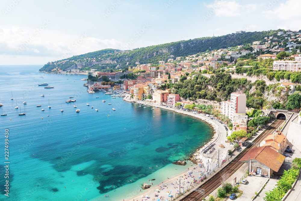 Bathers enjoy at the beach of the beautiful bay of Villefranche-sur-Mer on the Cote D'Azur